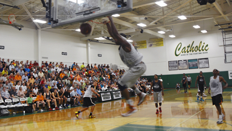 PHOTO BY DAN ANDREWS.  Michael Blue, playing for Rice Buick GMC, soars for a stuff to give his team a 9-point lead in the first half of the Pilot Rocky Top Basketball League’s championship game Wednesday night, July 2, at Knoxville Catholic High School. Campus Lights battled back and pulled out a 131-130 win.