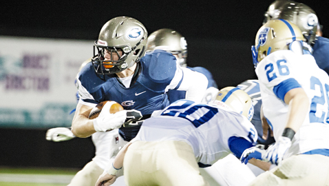 PHOTO BY KARA MCKAMEY Grace Christian Academy’s Cameron Kuerschen rushes for yardage against rival CAK in 2013. The Rams’ senior tailback will be a key offensive weapon for Grace this season.