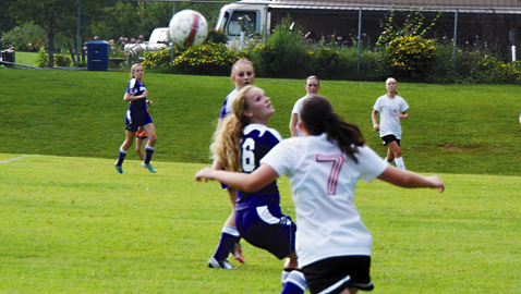 Photo by Dan Andrews. Halls High School sophomore soccer player Taylor Grabner (7) battles for the ball with Sevier County’s Megan Price in the season opener for both schools. The Lady Devils prevailed 2-1 in Tuesday’s match.