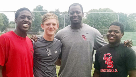 New Central High football coach Bryson Rosser shares a photo opportunity with three of his returning starters Thursday. From left, free safety Cedric Washington, quarterback Austin Kirby, Coach Rosser and running back Jeremiah Howard.