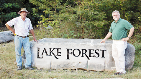 Buddy Mulkey of Island Home Granite, Signs and Monuments (left) and David Gilbert, Program Coordinator for the Communications Graphics Technology at Pellissippi State, at the new neighborhood sign. Gilbert, a 40 year Lake Forest resident, created the 1982 World’s Fair Logo. (Photo courtesy of Molly Gilbert)