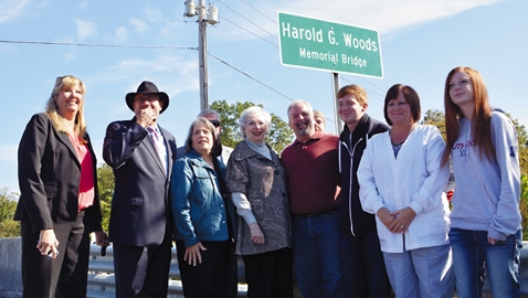 Photo by Dan Andrews. Local leaders and friends and family of the late Harold G. Woods gathered last week to dedicate a bridge to his memory.