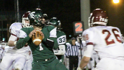 PHOTO BY CATHY DOWHOS-O’GORMAN Webb quarterback Brock Beeler hangs in the pocket, with ECS end Christian Rosenberger (26) closing in, to make a pass during the Spartans’ 21-7 win over the Eagles in Friday night semifinal action at Faust Field. 