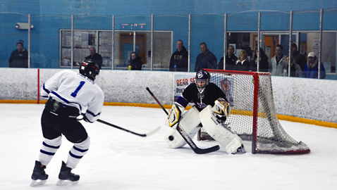 Photo by dan andrews. Knoxville Warriors’ forward Michael Thompson attempts to screen Bearden/Karns goaltender Braden Ross. Ross made 23 saves in the Ice Dawgs’ 6-3 win over Knoxville Thursday night.