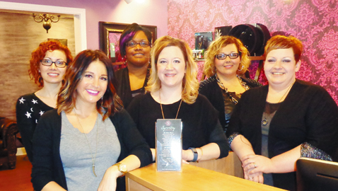 Photo by Mike Steely Erin Goode, center, and her professional staff at Symmetry Salon and Spa welcome you.