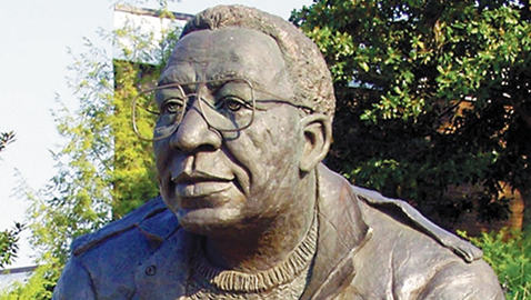 The statue of Alex Haley sits looking out over Morningside Park, taken before someone stole his glasses.