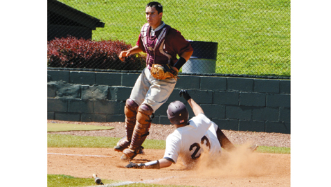 Photo by Dan Andrews. Bearden’s Paul Underwood slides home past Oak Ridge catcher Chris Romannowski for the first run in the Bulldogs’ 10-0 victory over the Wildcats Thursday afternoon at Farragut.