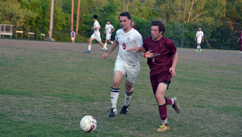 South-Doyle's Allen Kidd (9) battles with Morristown West's Matt Sawyer for the ball in the Trojans' 3-0 win over the Cherokees Wednesday night in the District 2-AAA Tournament. Sawyer scored the first goal of the match.
