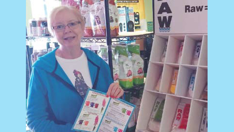 Photo by Mike Steely. Charlotte Nance volunteers at Green Grow Garden Shop and explains a new product there.