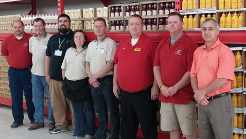 Photo by Mike Steely United Grocery Outlet CEO Michael Tullock (right) and Chapman manager Matt Storm are pictured with the new store’s staff. The UGO company is the largest close-out grocery company in the Eastern United States. 