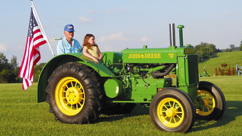  Grady Lett with his little side-kick, granddaughter Abbey, on his oldest John Deere tractor, a 1935 AR (“A” designates size; “R” stands for “row crop”) 