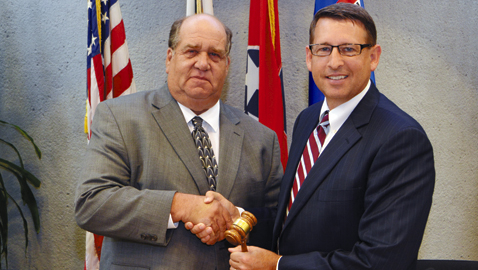 Photo by Dan Andrews. Knox County School Board outgoing chairman Mike McMillan passes the gavel to newly elected chairman Doug Harris.