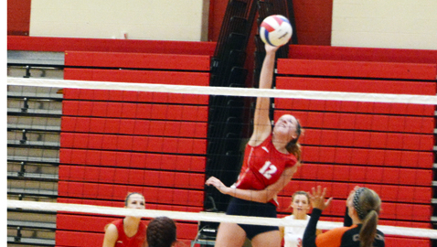 Halls High middle blocker Micah DePetro makes the winning spike in the Lady Devils four-set victory over Clinton Tuesday night at Halls.